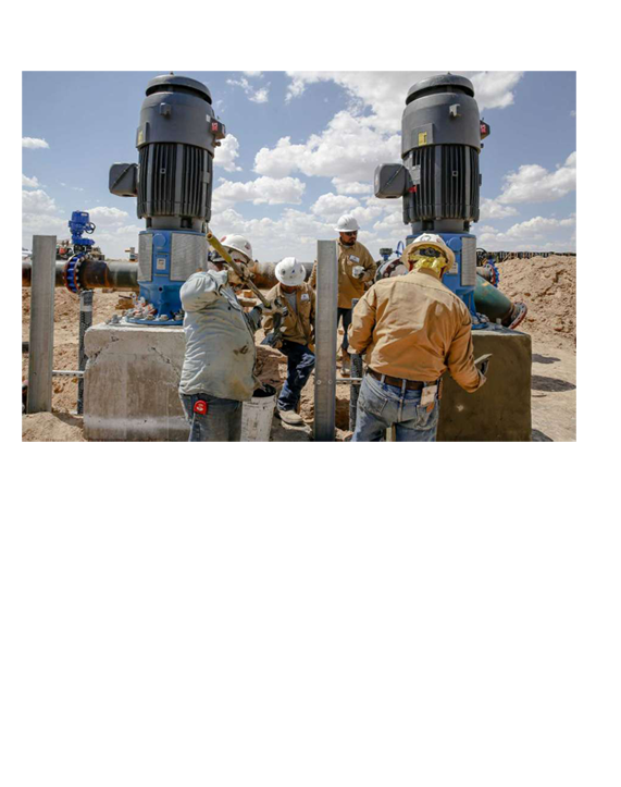 Men working in hard hats and a Layne map